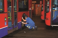 A driver carries out a check at Metroline garage in north London