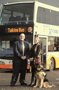Ben Hobday, project manager at Travel de Courcey, with Beverley Muldoon and her guide dog, Fifi with an X6-branded Optare Olympus behind