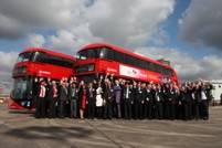 Attendees cheer in front of two New Buses for London