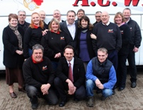 Owner Glen Pratt, centre standing, with the A C Williams team