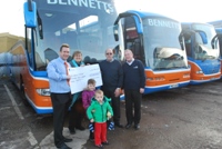 Gavin Bennett, Workshop Manager, Audrey Williams, South West Regional Fundraising Manager for the Cystic Fibrosis Trust, Martyn Starkey, Coach Driver and Peter Bennett, Managing Director. Front row: Isabella Starkey (6) and James Starkey (3)