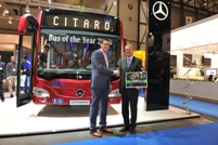 Hartmut Schick (r), Head of Daimler Buses and CEO of EvoBus GmbH, receives a certificate to commemorate the delivery of the 25,000th Groeneveld Oilmaster to EvoBus, from Johan Bood of Groeneveld
