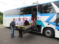 Stephan Frank, Across Transport Manager (left) and Andy Palmer, PLS UK Sales Manager (right) with the King Long coach fitted with a PLS stretcher lift