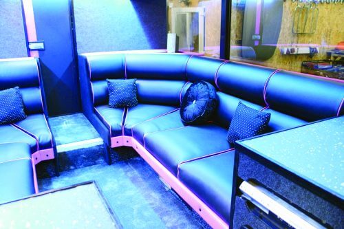 The downstairs seating area has been modernised with new black and pink leather upholstery. The glittery slate-coloured carpet can also be seen here. JADE SMITH