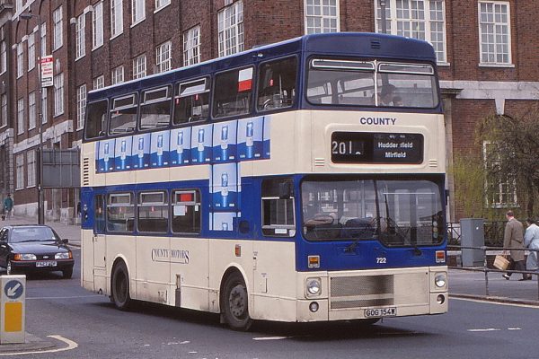An ex-West Midlands PTE MCW Metrobus new in 1980 that was painted in County Motors livery by West Riding. It was approaching the Eastgate roundabout near the Central Bus Station in Leeds during April 1991