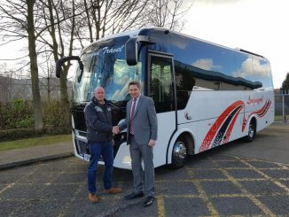 The Proprietor of Longmynd Travel Ltd, Mark Sheppard, is seen collecting the Indcar Next L8 from Dale Johnson of Moseley (PCV) Ltd on the right. MOSELEY